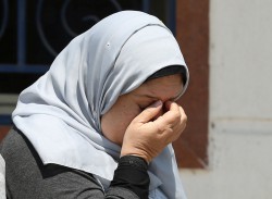 An unidentified woman reacts as she waits outside the Egyptair in-flight service building, where relatives and friends of passengers who were flying in an EgyptAir plane that vanished from radar en route from Paris to Cairo are being held, at Cairo International Airport, Egypt May 19, 2016. REUTERS/Mohamed Abd El Ghany